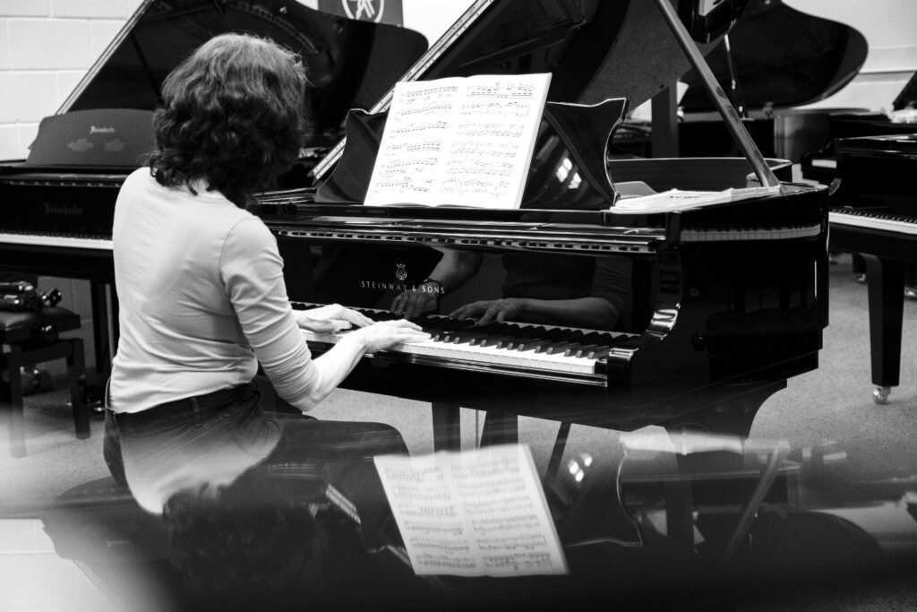 Lady playing Steinway & Sons grand piano